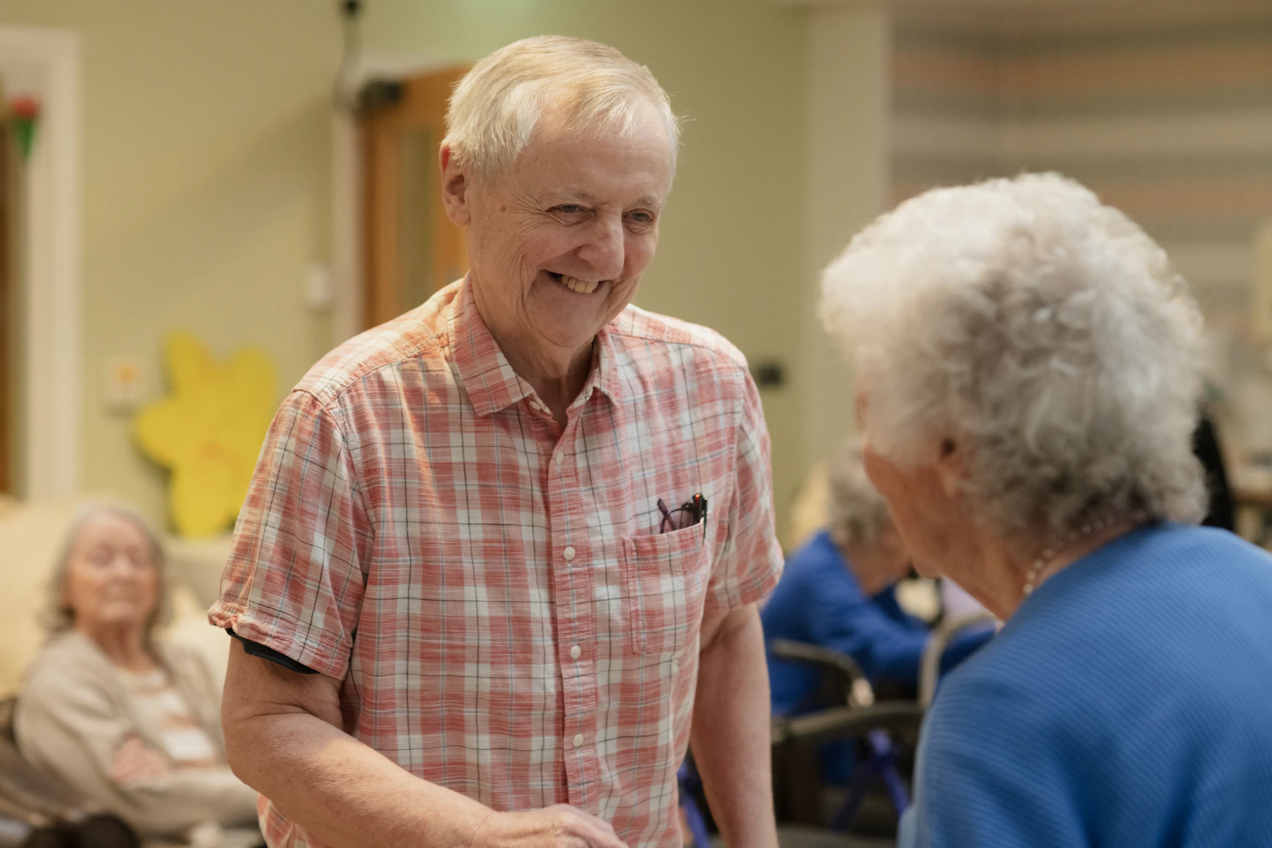 Older people talking together in a welcoming community room